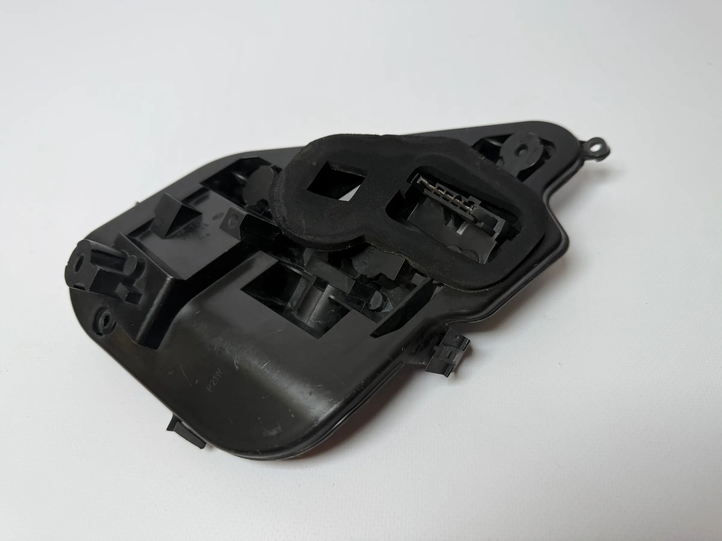 Oryginalny uchwyt lampy tylnej Opel Astra H (A04) Hella 160916-00 / 159728